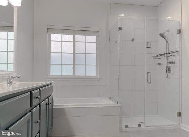 bathroom featuring a bath, a shower stall, vanity, and a healthy amount of sunlight