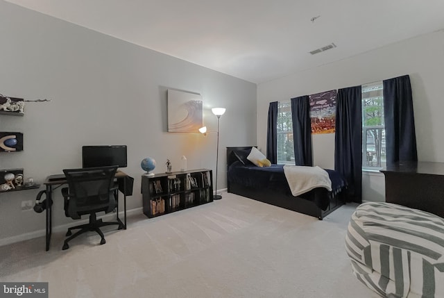 bedroom featuring visible vents, baseboards, and carpet