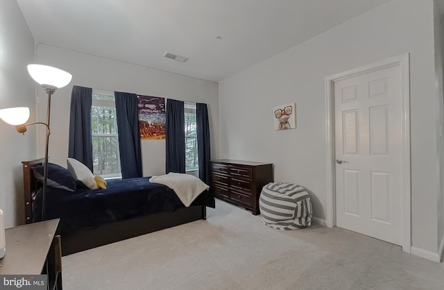bedroom featuring light colored carpet, baseboards, and visible vents