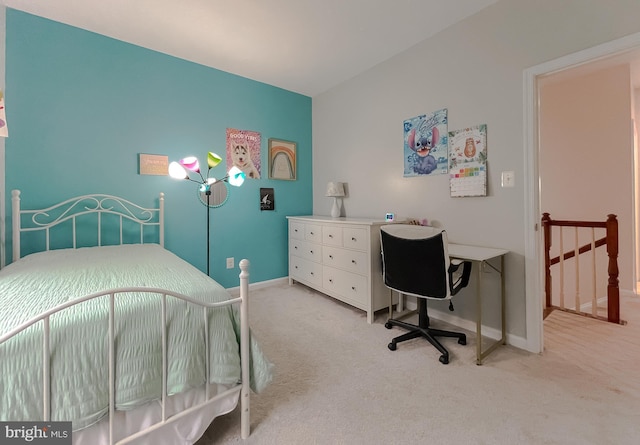 bedroom with light colored carpet and baseboards