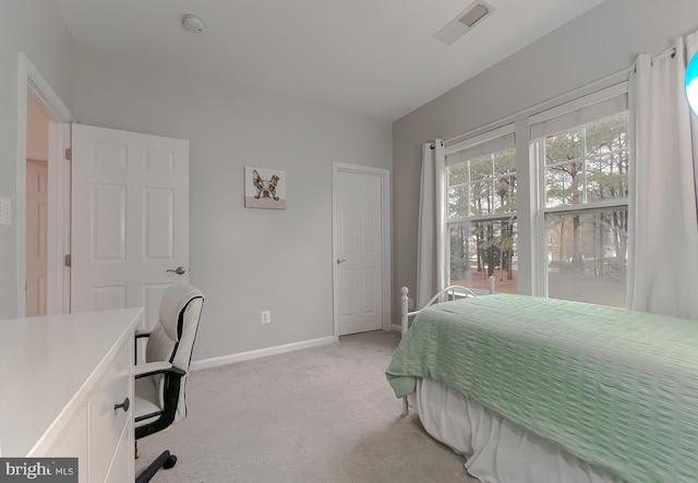 bedroom with visible vents, baseboards, and light colored carpet