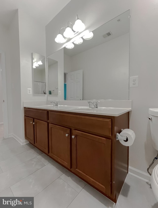 full bath with baseboards, tile patterned flooring, toilet, visible vents, and a sink