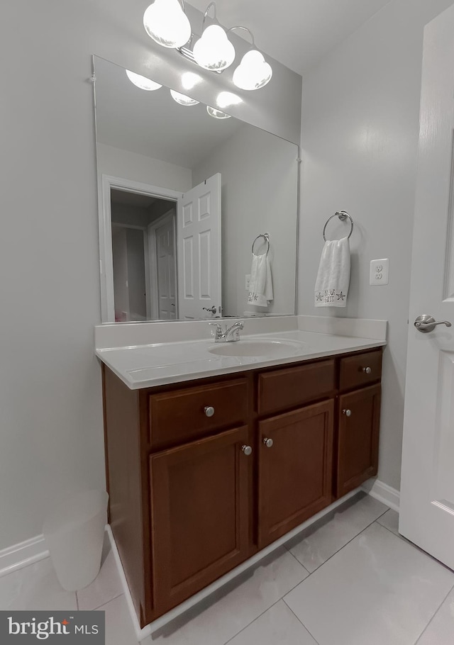 bathroom with tile patterned floors, vanity, and baseboards