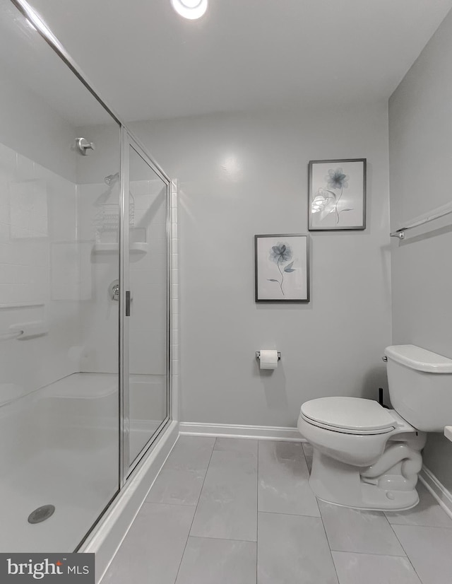 full bathroom with toilet, baseboards, marble finish floor, and a stall shower