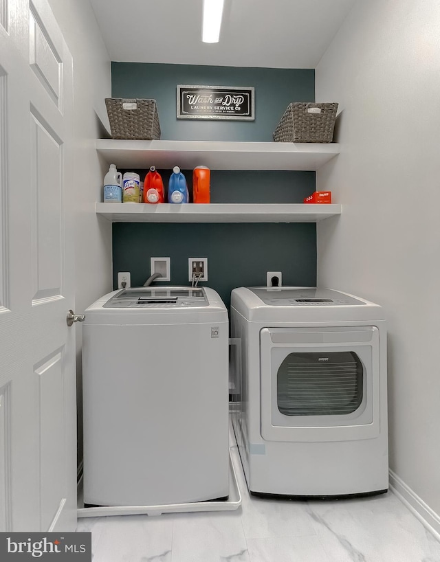 washroom featuring washer and dryer and laundry area