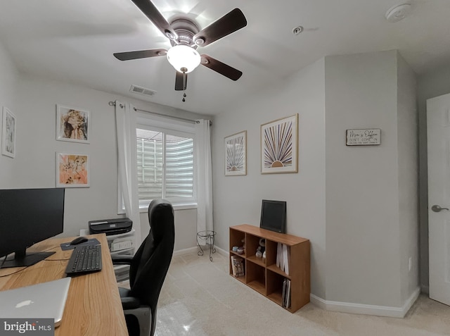office with visible vents, baseboards, a ceiling fan, and light carpet