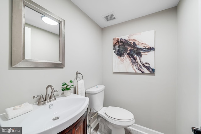 3568 S George Mason Dr Unit 12, Alexandria, VA 22302 - bathroom with baseboards, visible vents, vanity, and toilet