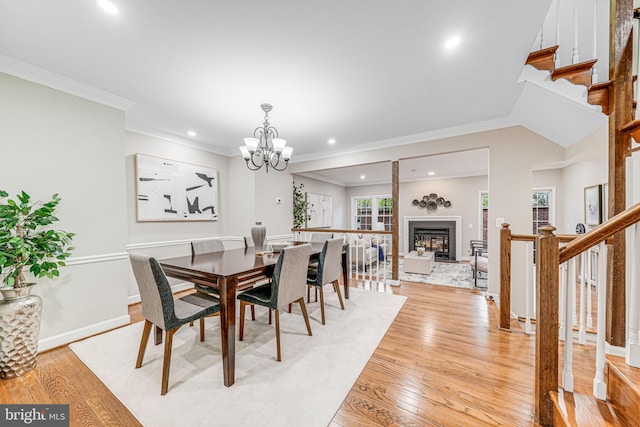3568 S George Mason Dr Unit 12, Alexandria, VA 22302 - dining area featuring a glass covered fireplace, a chandelier, stairs, and light wood-style floors