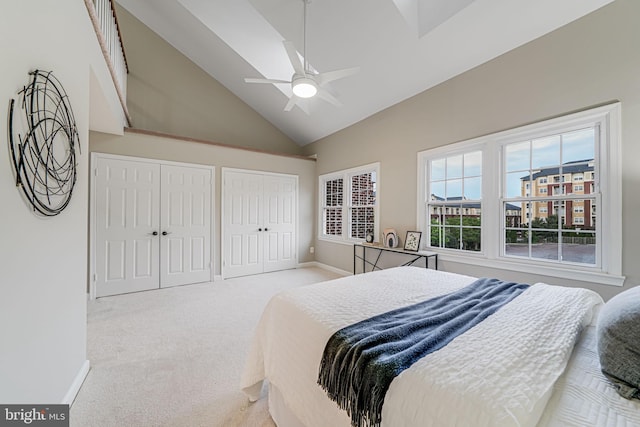 3568 S George Mason Dr Unit 12, Alexandria, VA 22302 - bedroom featuring high vaulted ceiling, a ceiling fan, two closets, light colored carpet, and baseboards