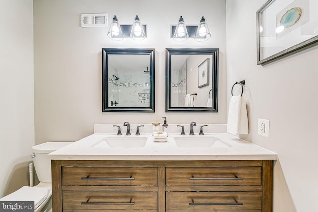 3568 S George Mason Dr Unit 12, Alexandria, VA 22302 - bathroom with double vanity, visible vents, toilet, and a sink