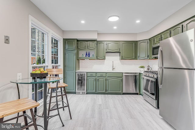 3568 S George Mason Dr Unit 12, Alexandria, VA 22302 - kitchen with beverage cooler, green cabinetry, and stainless steel appliances