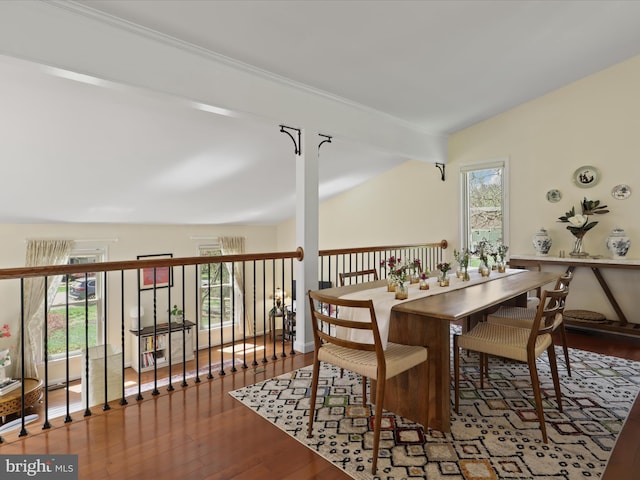 dining area with wood finished floors and lofted ceiling