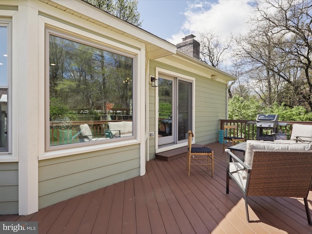 deck featuring grilling area and outdoor lounge area