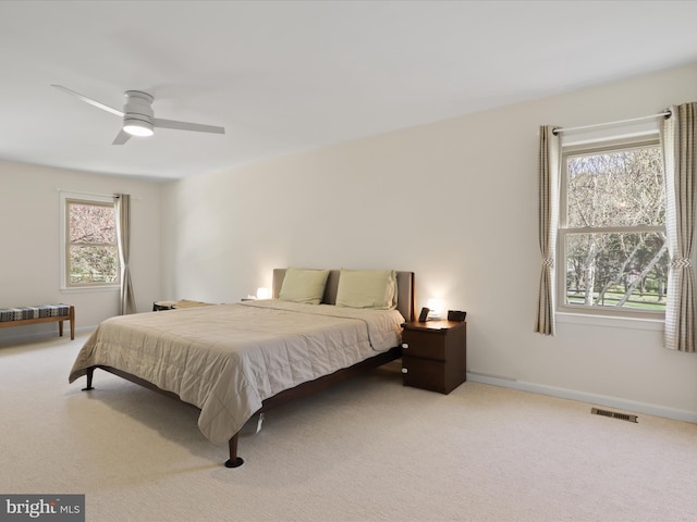 bedroom with carpet, visible vents, and baseboards