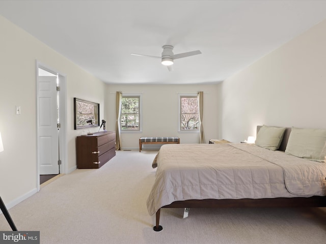 carpeted bedroom featuring radiator heating unit, baseboards, and a ceiling fan