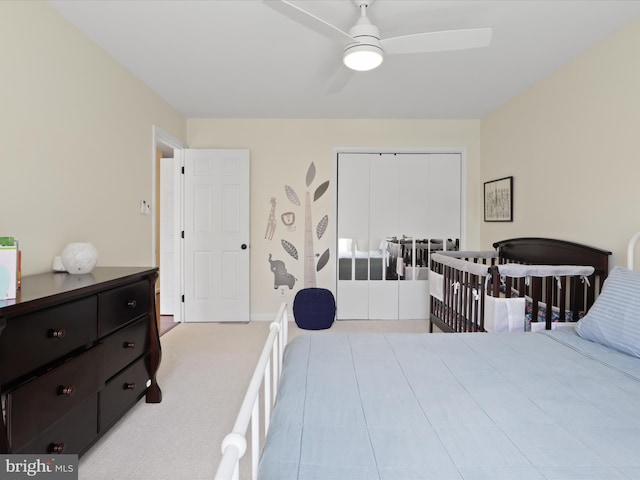 carpeted bedroom with a closet and a ceiling fan