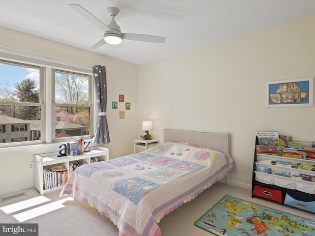 carpeted bedroom with ceiling fan, baseboards, and visible vents