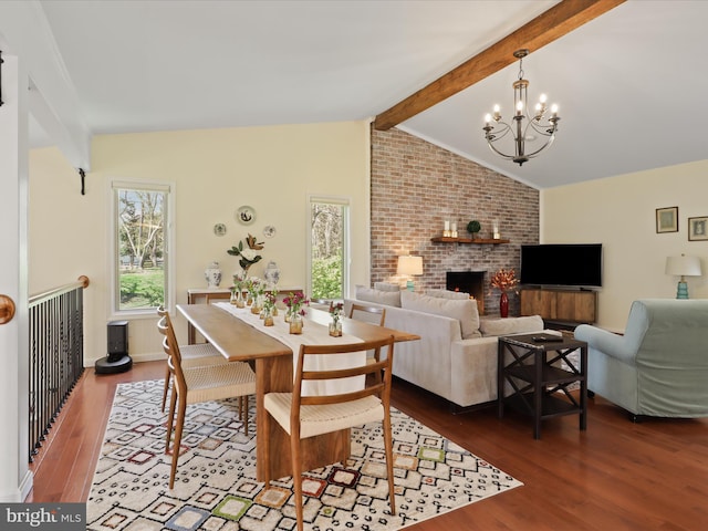 dining area with wood finished floors, an inviting chandelier, vaulted ceiling with beams, and a healthy amount of sunlight