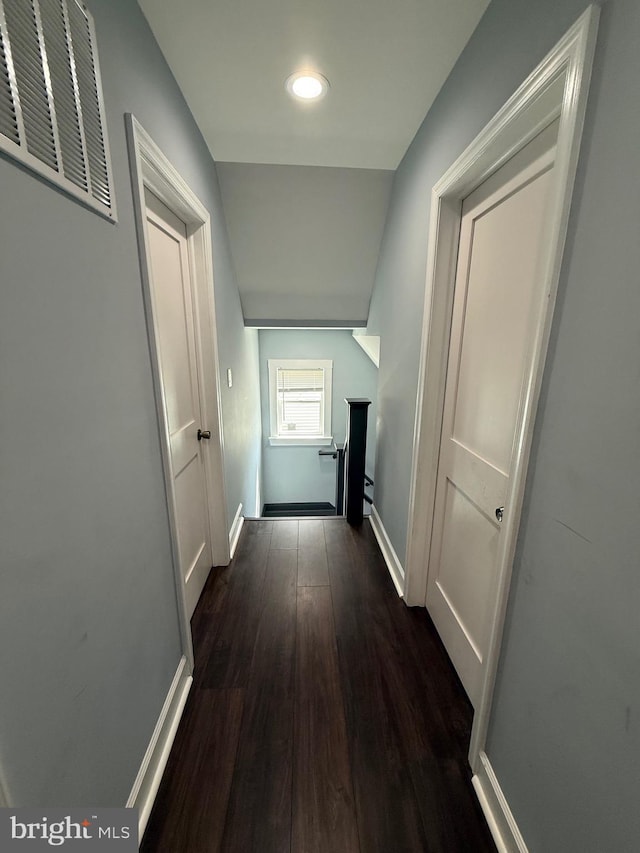 corridor with recessed lighting, dark wood finished floors, visible vents, and baseboards