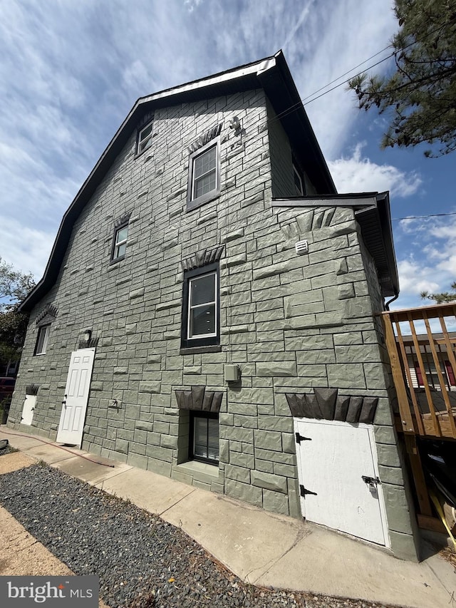 view of side of property with stone siding