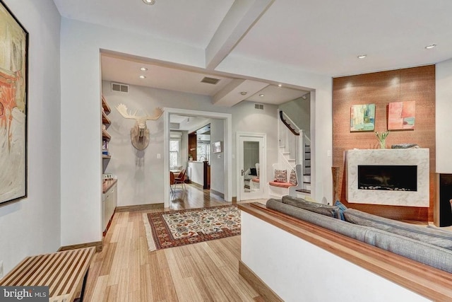 hall featuring recessed lighting, stairway, light wood-style flooring, and baseboards
