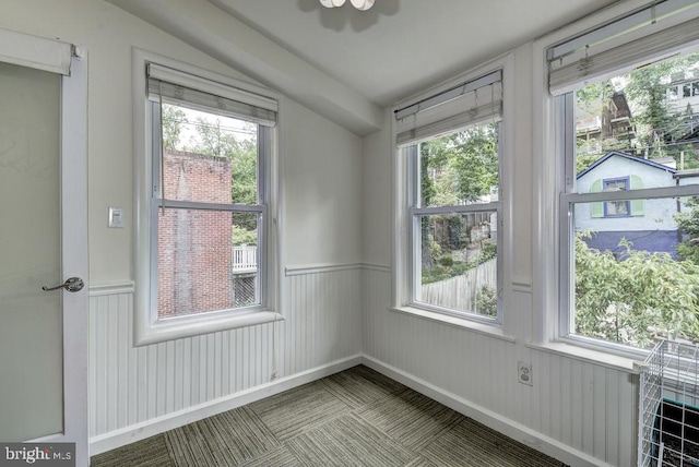 spare room featuring plenty of natural light and wainscoting