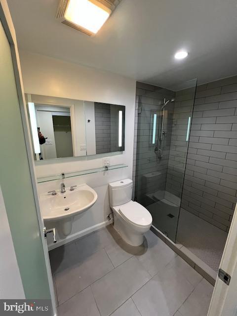 full bathroom with a shower stall, a sink, toilet, tile patterned flooring, and recessed lighting