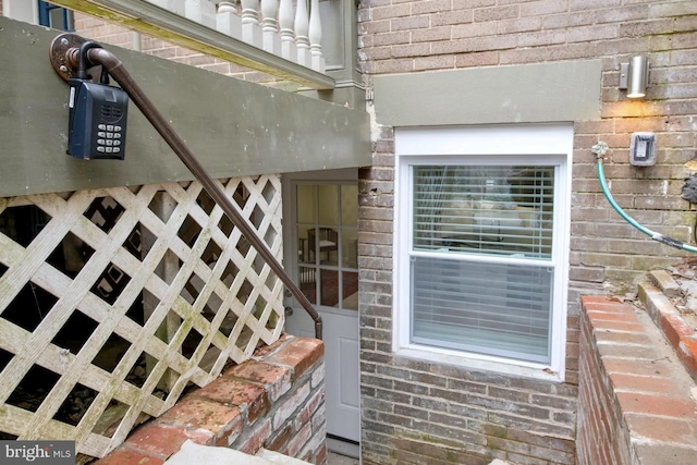 view of exterior entry featuring brick siding