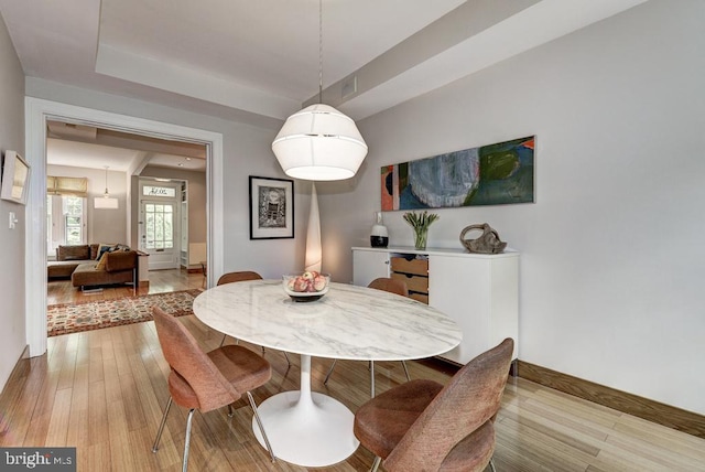 dining room with light wood-type flooring and baseboards