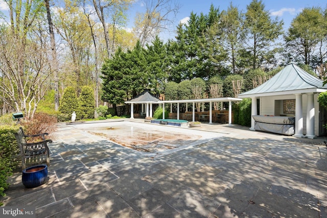 exterior space featuring a gazebo, a patio, a swimming pool, and a hot tub