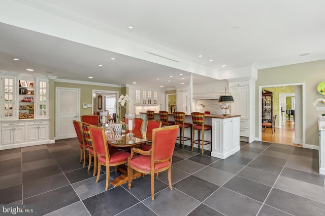 dining space with ornamental molding, recessed lighting, and dark tile patterned flooring
