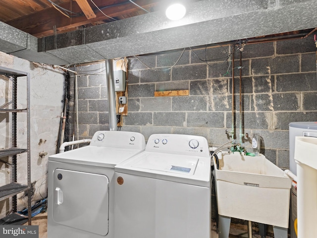 laundry room with washing machine and dryer, a sink, and laundry area