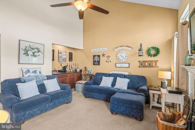 living room featuring high vaulted ceiling, ceiling fan, carpet, and indoor bar