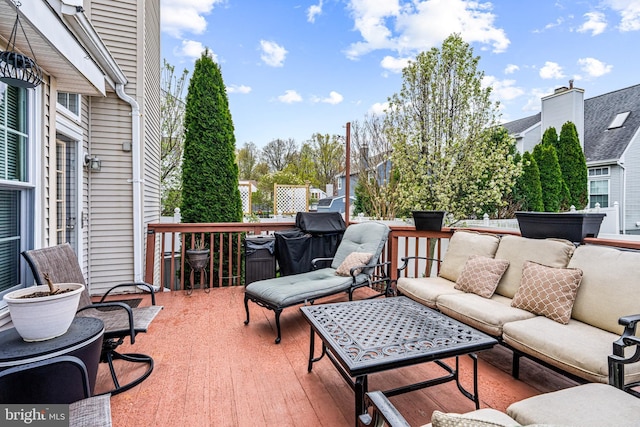deck with area for grilling and an outdoor hangout area