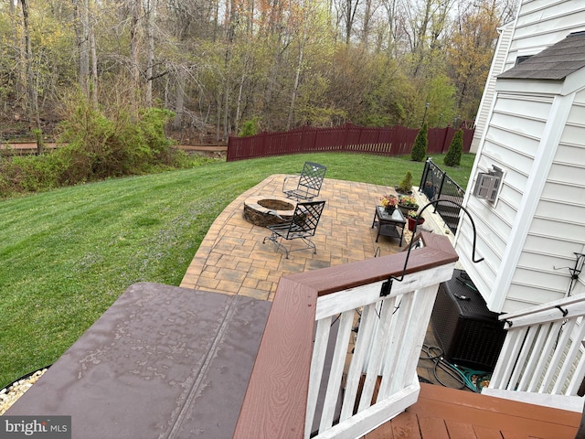 exterior space with a patio, an outdoor fire pit, fence, and a yard