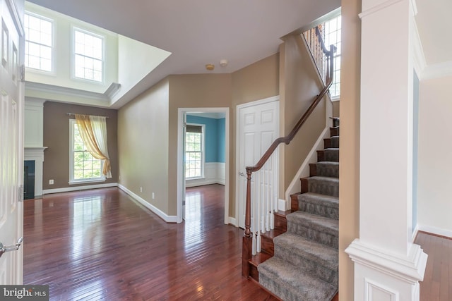 9184 Laurel Highlands Pl, Manassas, VA 20112 - foyer featuring stairs, wood finished floors, a glass covered fireplace, and baseboards