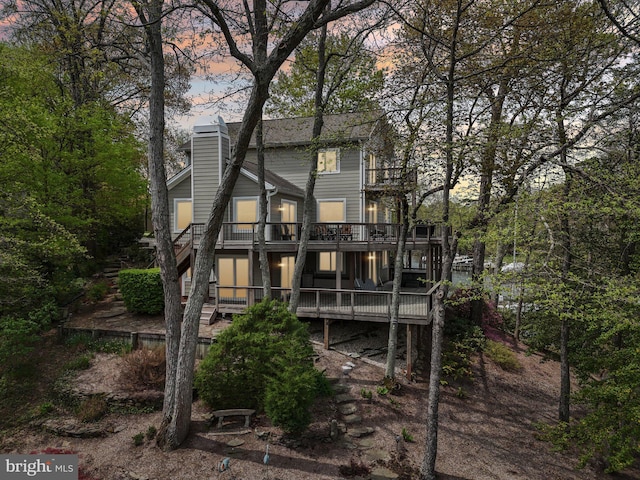 264 Capote Ct E, Severna Park, MD 21146 - back of property at dusk with a deck, a chimney, stairway, and a balcony