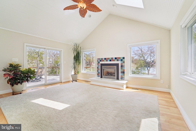 264 Capote Ct E, Severna Park, MD 21146 - unfurnished living room featuring healthy amount of natural light, a ceiling fan, a skylight, light wood-type flooring, and high vaulted ceiling