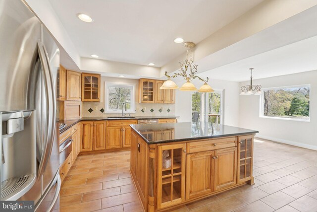 264 Capote Ct E, Severna Park, MD 21146 - kitchen with stainless steel appliances, a sink, backsplash, glass insert cabinets, and plenty of natural light