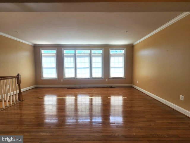 unfurnished room with hardwood / wood-style floors, plenty of natural light, and crown molding