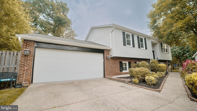 1601 Jubilation Ct, Herndon, VA 20170 - view of front facade with brick siding, concrete driveway, an attached garage, and fence
