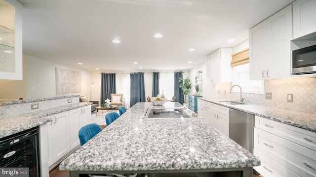 1601 Jubilation Ct, Herndon, VA 20170 - kitchen with wine cooler, a sink, appliances with stainless steel finishes, recessed lighting, and white cabinets