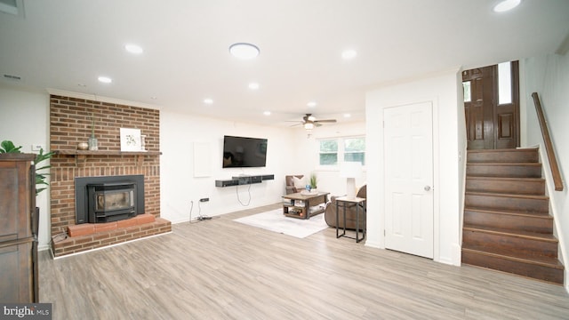 1601 Jubilation Ct, Herndon, VA 20170 - living area with stairs, light wood-style flooring, recessed lighting, a ceiling fan, and a wood stove