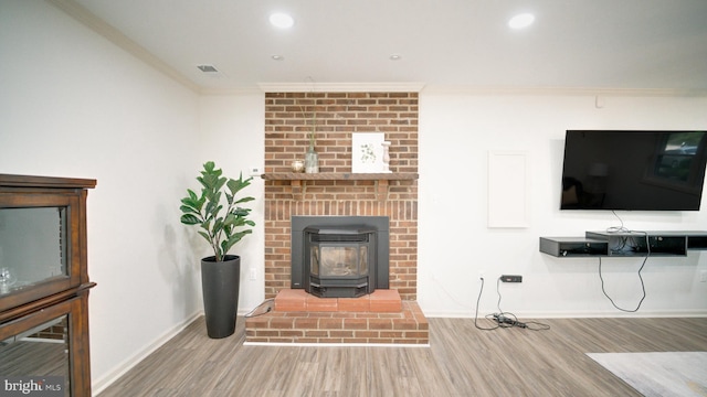 1601 Jubilation Ct, Herndon, VA 20170 - living area with ornamental molding, wood finished floors, baseboards, recessed lighting, and a wood stove