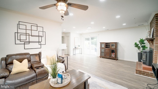1601 Jubilation Ct, Herndon, VA 20170 - living room featuring a wood stove, ceiling fan, light wood finished floors, recessed lighting, and baseboards