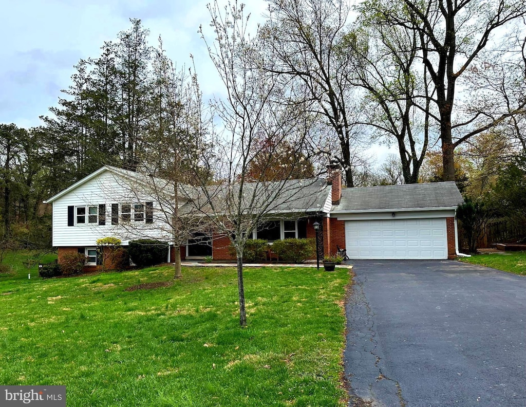 6515 Walters Woods Dr, Falls Church, VA 22044 - tri-level home with an attached garage, aphalt driveway, and a front yard