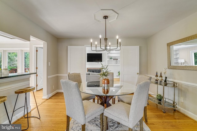 6515 Walters Woods Dr, Falls Church, VA 22044 - dining room featuring light wood-type flooring, baseboards, and an inviting chandelier