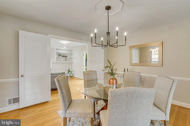 6515 Walters Woods Dr, Falls Church, VA 22044 - dining room with baseboards, wood finished floors, visible vents, and a notable chandelier