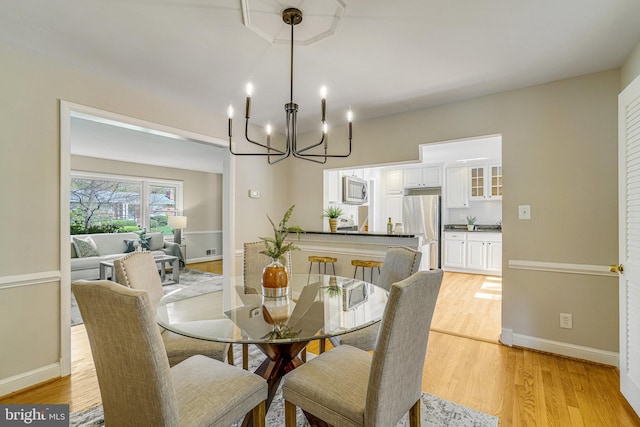 6515 Walters Woods Dr, Falls Church, VA 22044 - dining space featuring light wood finished floors, baseboards, and a notable chandelier