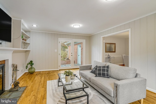 6515 Walters Woods Dr, Falls Church, VA 22044 - living area with a glass covered fireplace, light wood-type flooring, baseboards, and ornamental molding